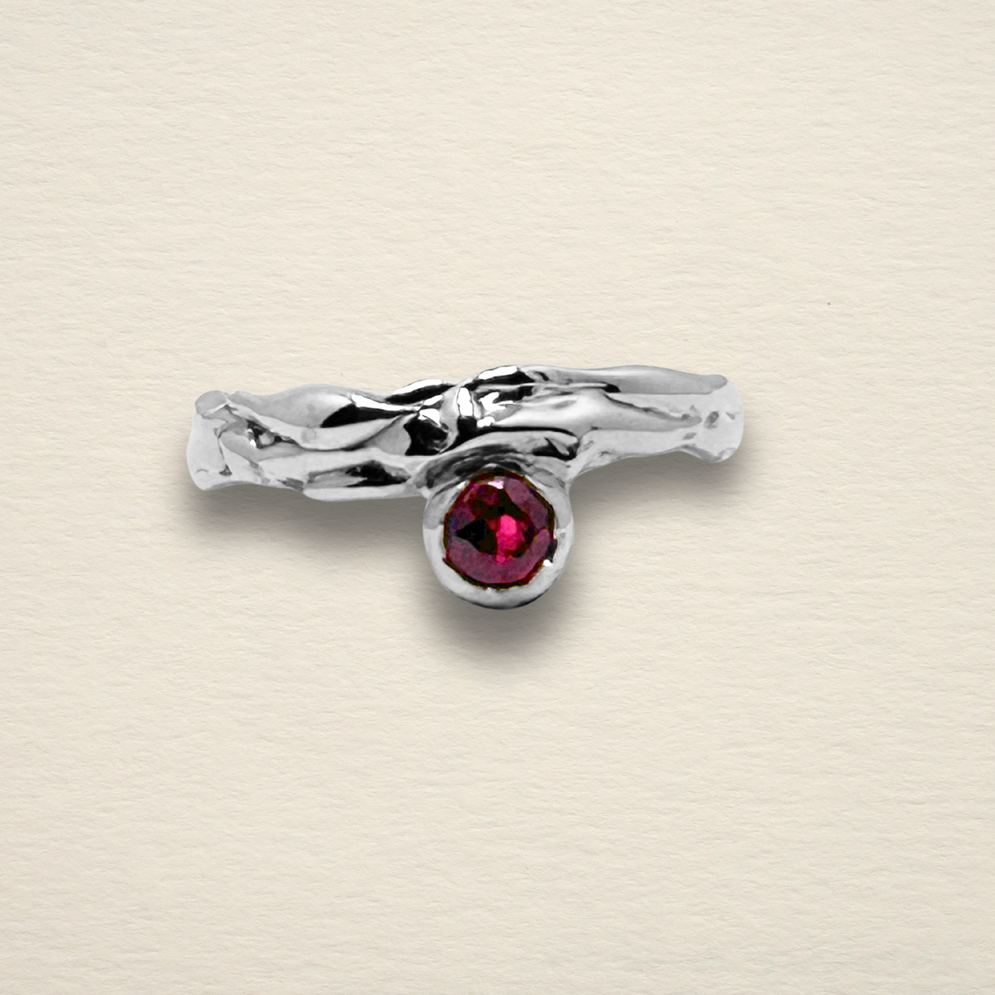 The Archive Series Rhodolite Garnet Solitaire: a 0.25ct rhodolite garnet burnish-set in an offset, hand-sculpted sterling silver band, master-fabricated in Chicago.