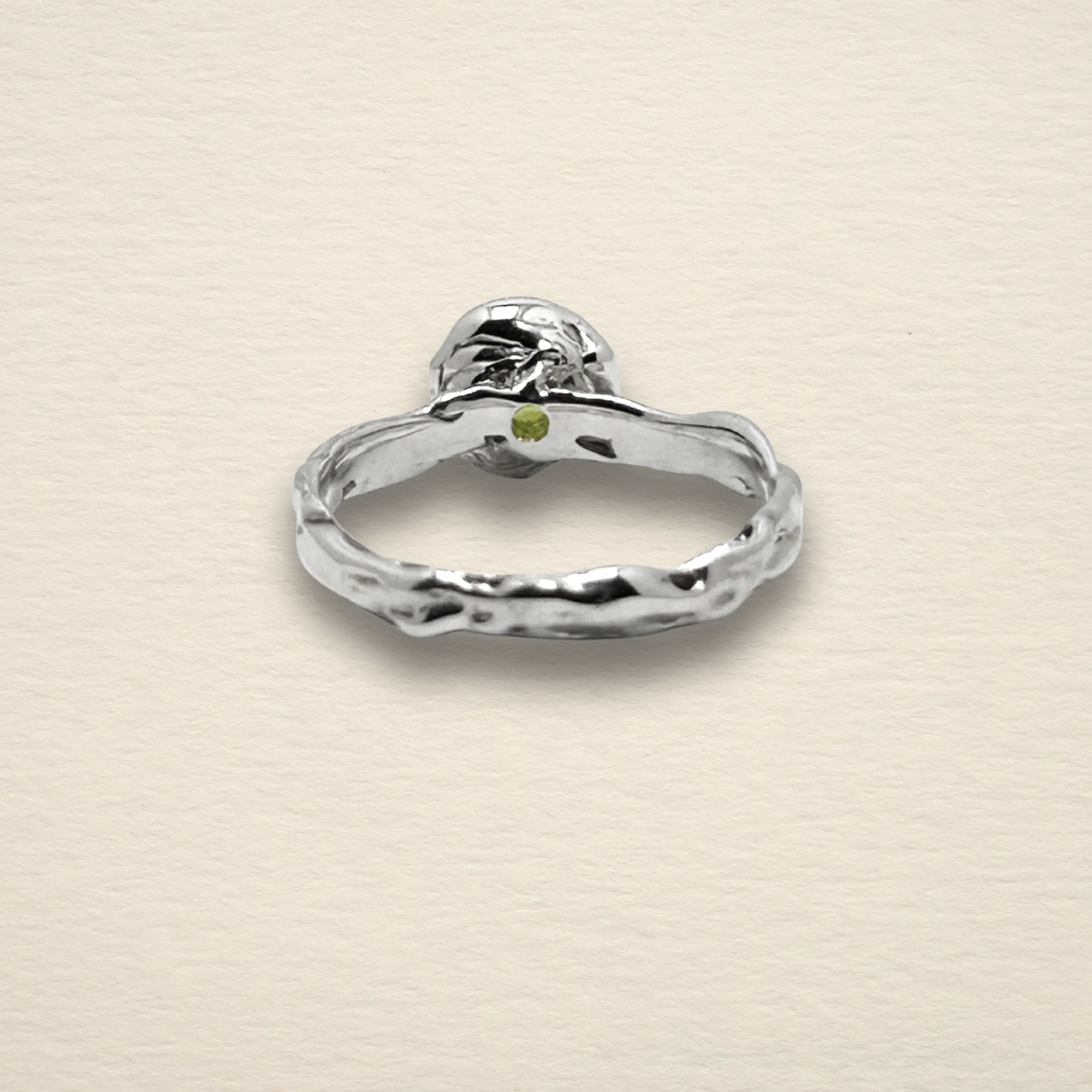 Underside view of the Archive Series Peridot Solitaire, displaying the hallmark of authentic master goldsmithing with precise, hand-finished metalwork in recycled sterling silver.