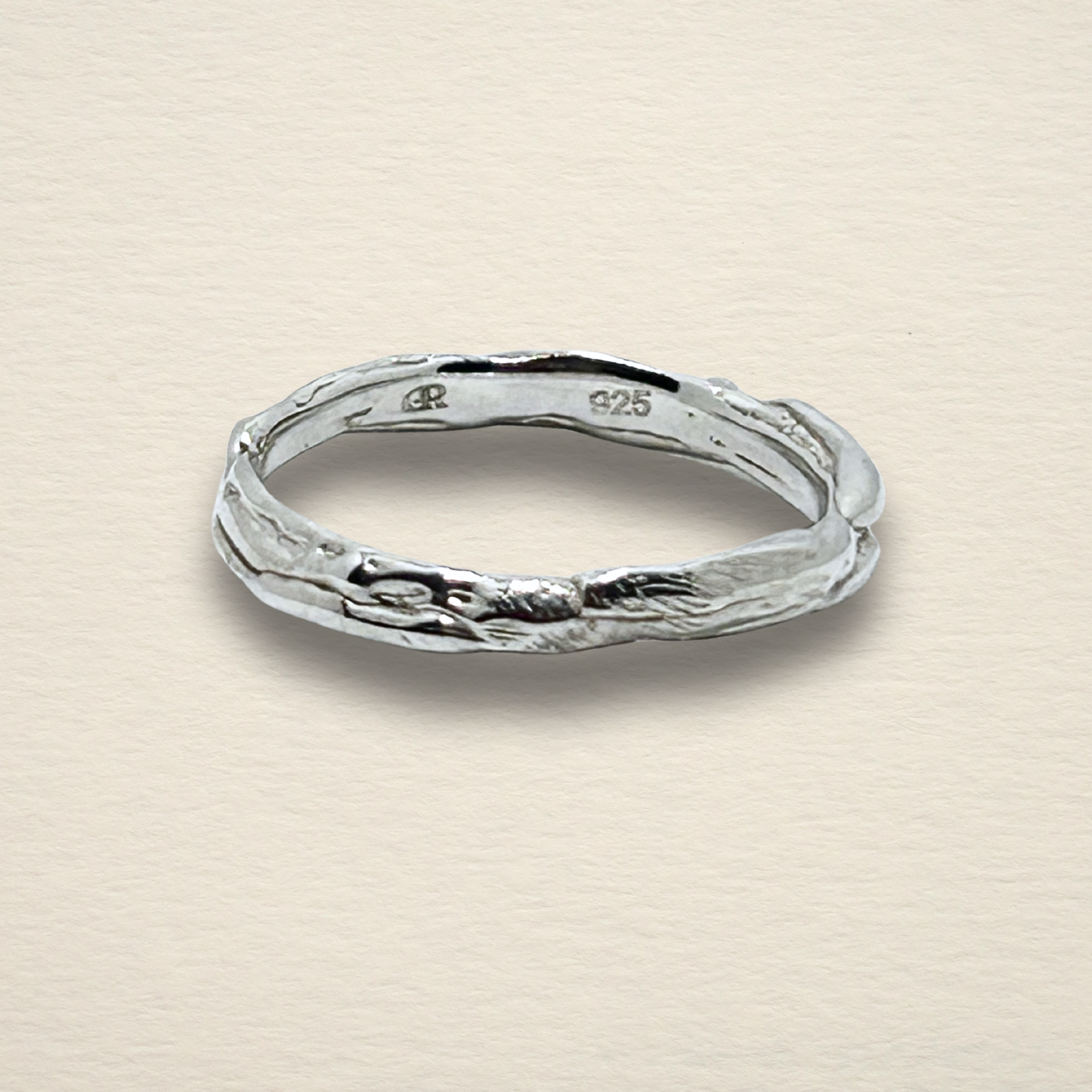 The Archive Series Sculpted Band: a plain, hand-sculpted sterling silver band featuring an organic, raw-edged texture, master-fabricated in Chicago.