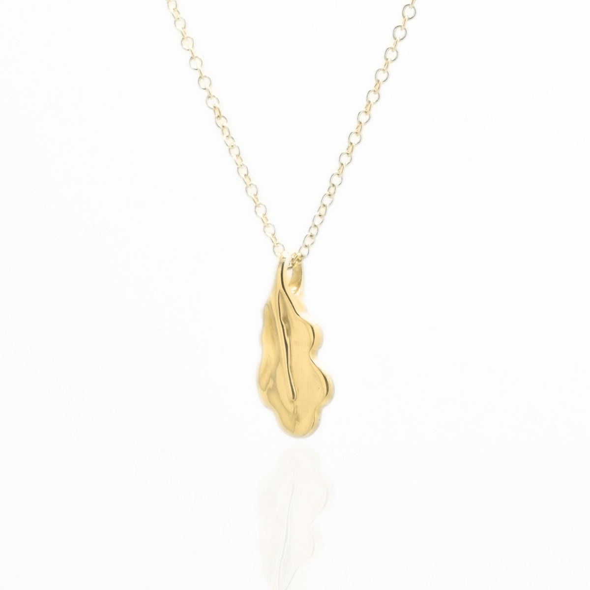 Direct studio front view of the Botanical Oak Leaf Pendant 15mm petite in solid 18k yellow gold, emphasizing tactile volume and fine jewelry craftsmanship.