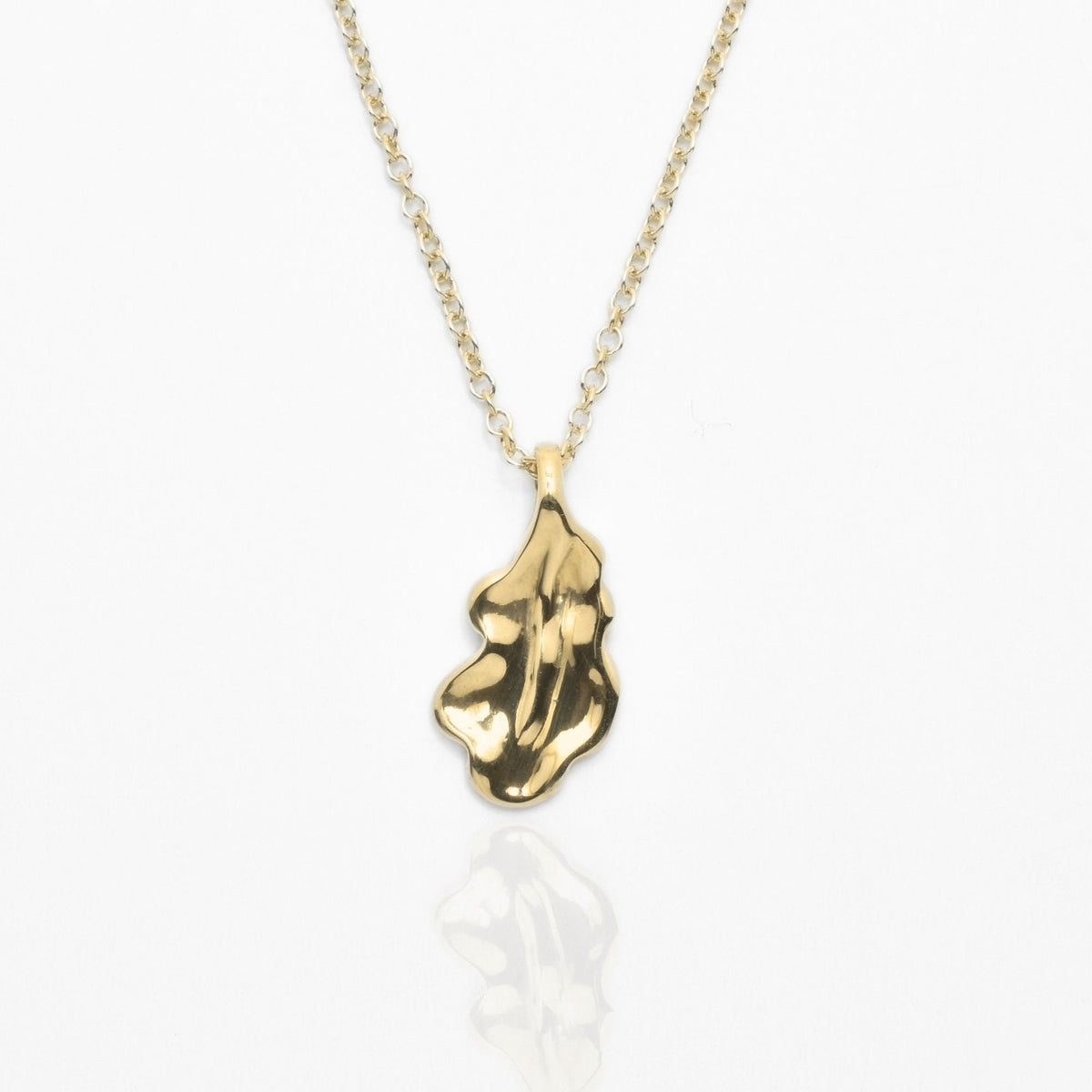 Studio front perspective of the Botanical Oak Leaf Pendant 15mm petite in solid 18k yellow gold by Gina Rose Atelier.
