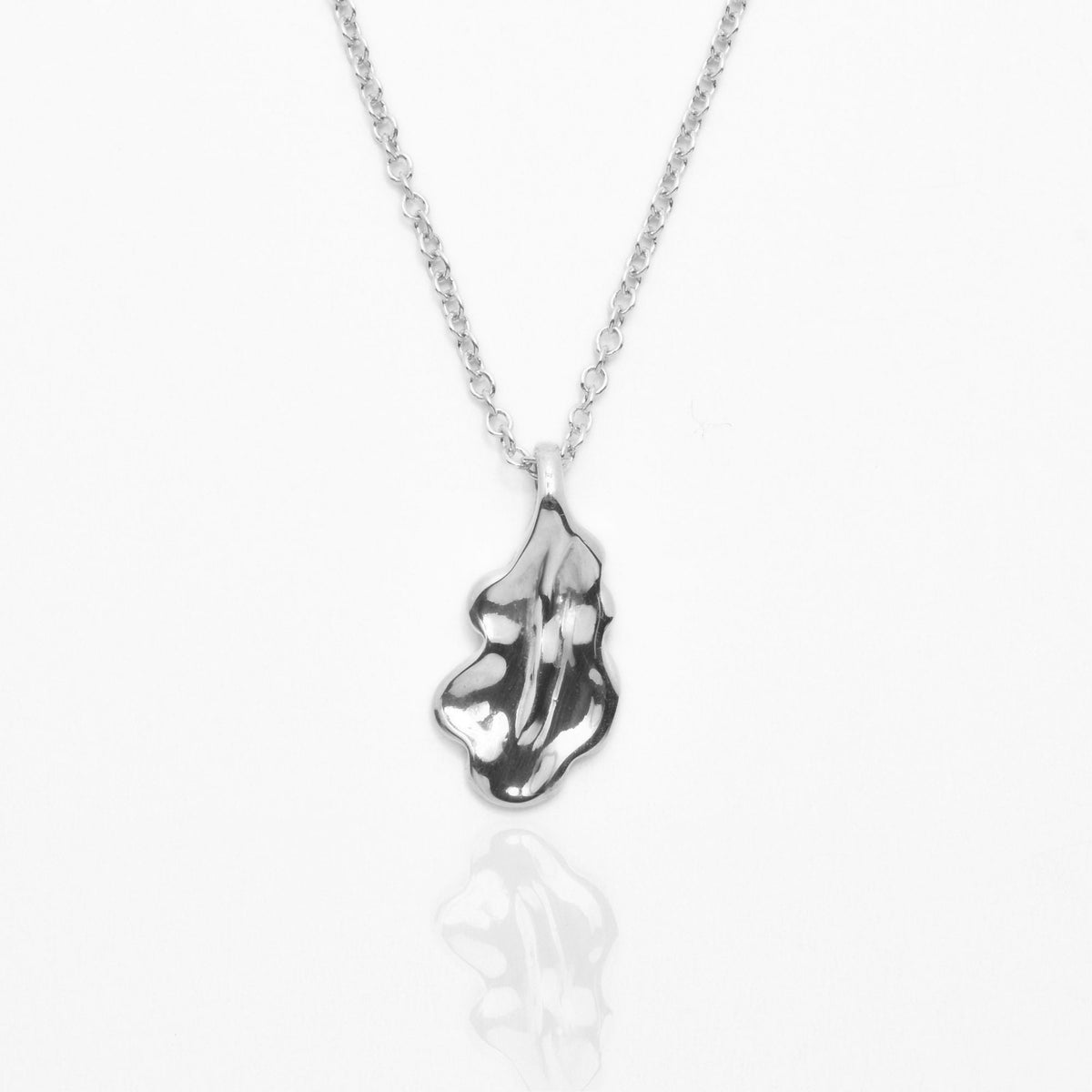 Dynamic studio perspective and reflection of the Botanical Oak Leaf Pendant 15mm petite in solid sterling silver by Gina Rose Atelier.
