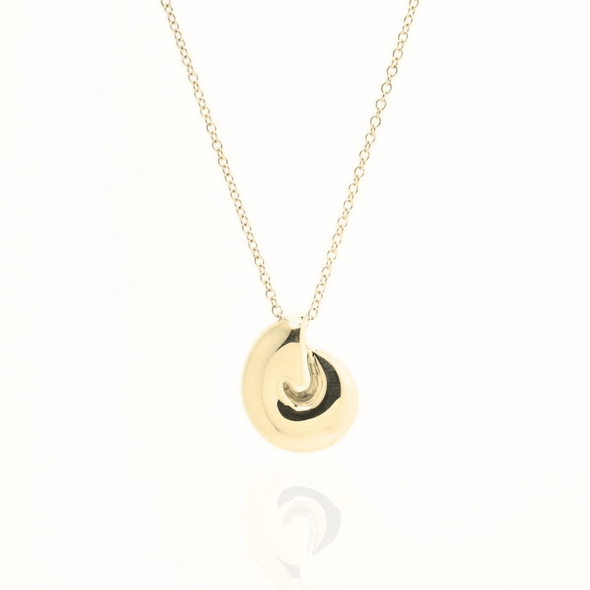 Close-up front view of the Pelagic Nautilus Pendant 14mm grande in 18k yellow gold, showcasing master-crafted logarithmic spiral geometry and polished finish by Gina Rose Atelier