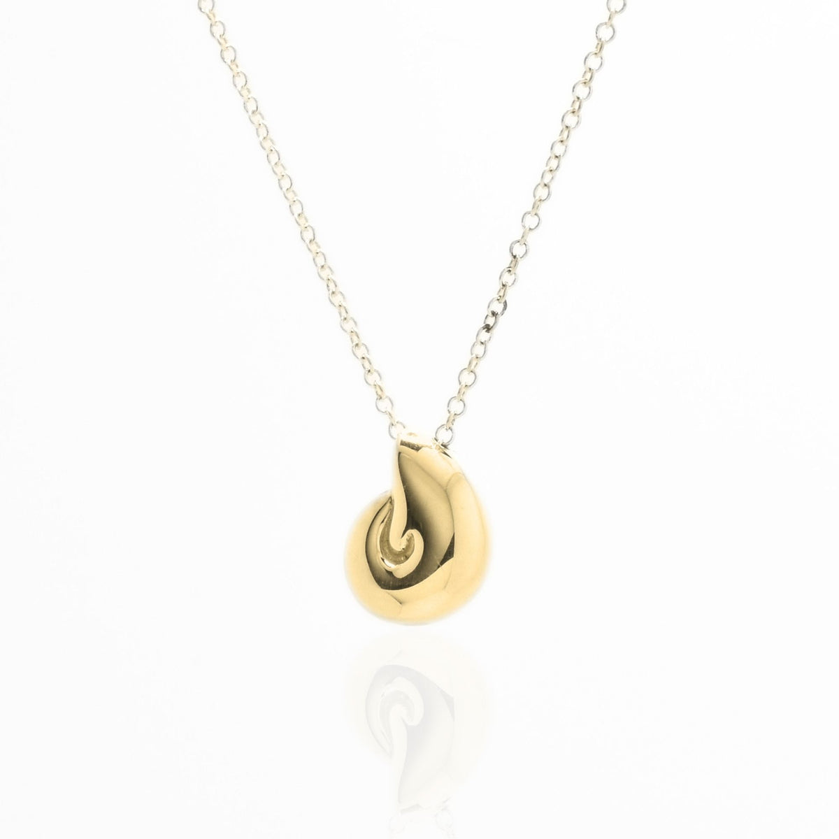 The Pelagic Nautilus Pendant in 11mm petite scale crafted in solid 18k yellow gold by Gina Rose Atelier, shown with a mirror studio reflection on a custom gold chain.
