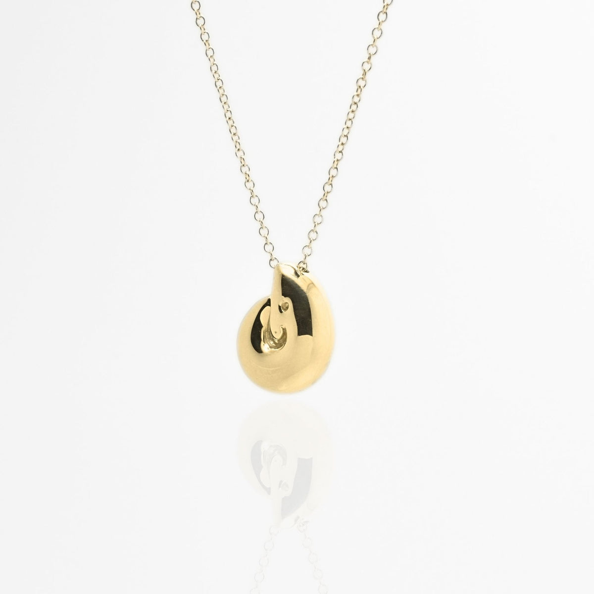 Direct studio front view of the Pelagic Nautilus Pendant 14mm grande in solid 18k yellow gold, emphasizing tactile volume and fine jewelry craftsmanship