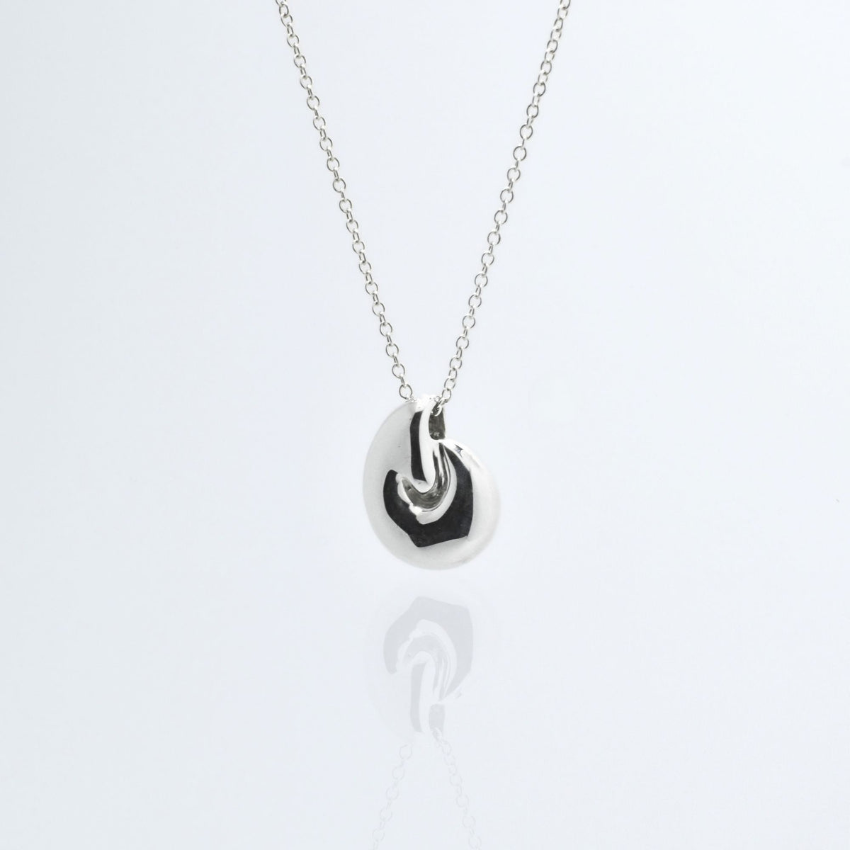 Direct studio front view of the Pelagic Nautilus Pendant 14mm grande in solid sterling silver, emphasizing tactile volume and fine jewelry craftsmanship