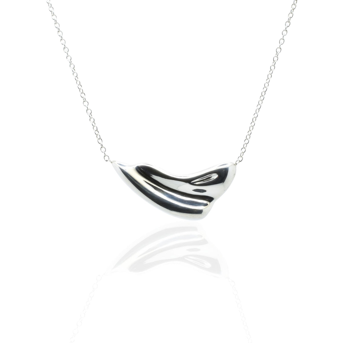 Close-up front view of the Pelagic Wave Pendant 24mm grande in sterling silver, showcasing master-crafted sweeping crest geometry and polished finish by Gina Rose Atelier