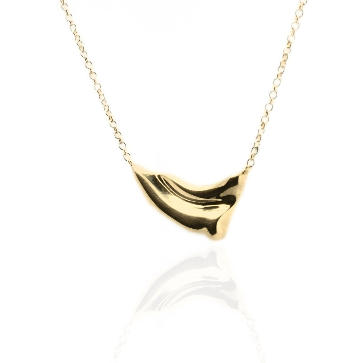 The Pelagic Wave Pendant in 18mm petite scale crafted in solid 18k yellow gold by Gina Rose Atelier, shown with a mirror studio reflection on a custom gold chain.