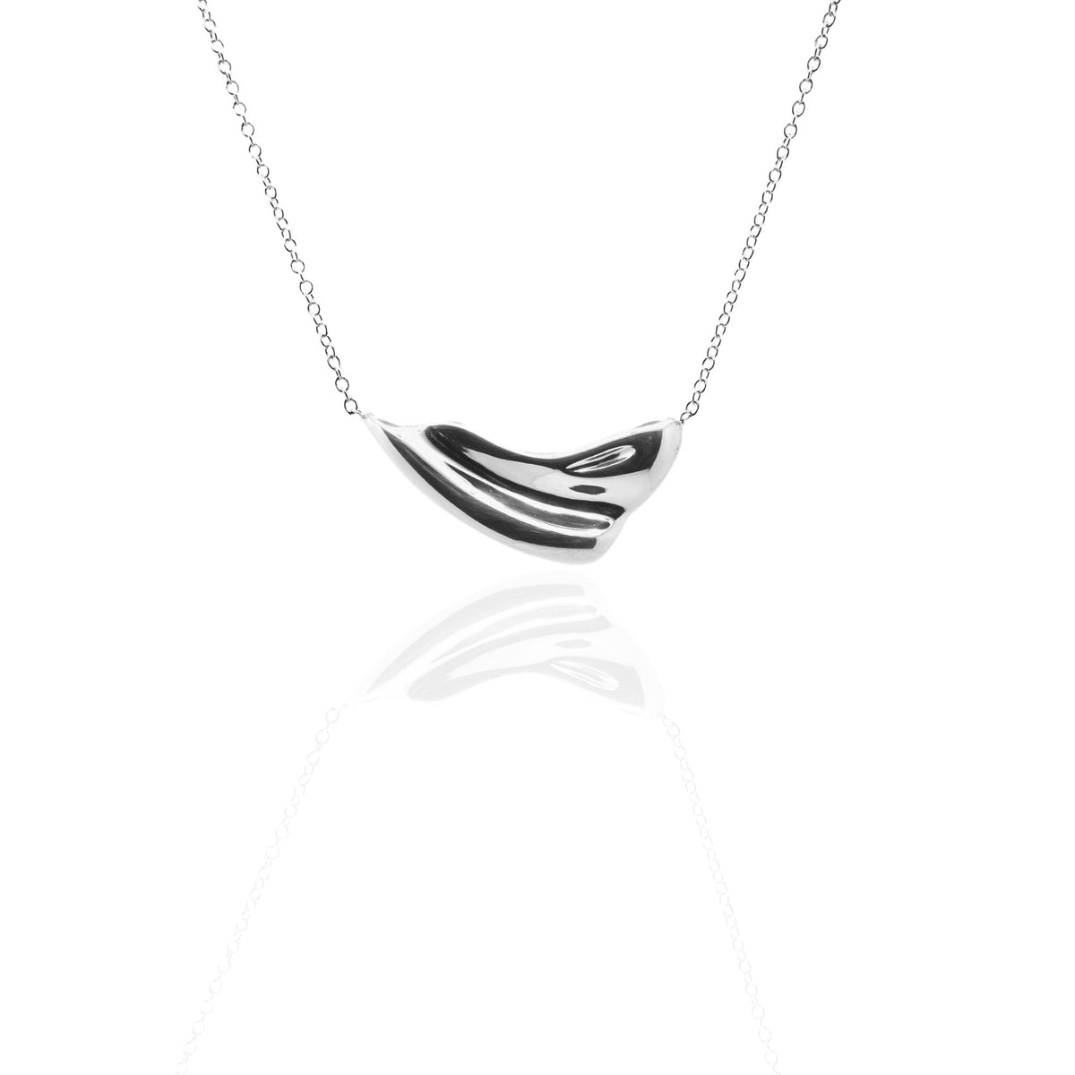 The Pelagic Wave Pendant in 24mm grande scale crafted in solid sterling silver by Gina Rose Atelier, shown with a mirror studio reflection on a custom silver chain.