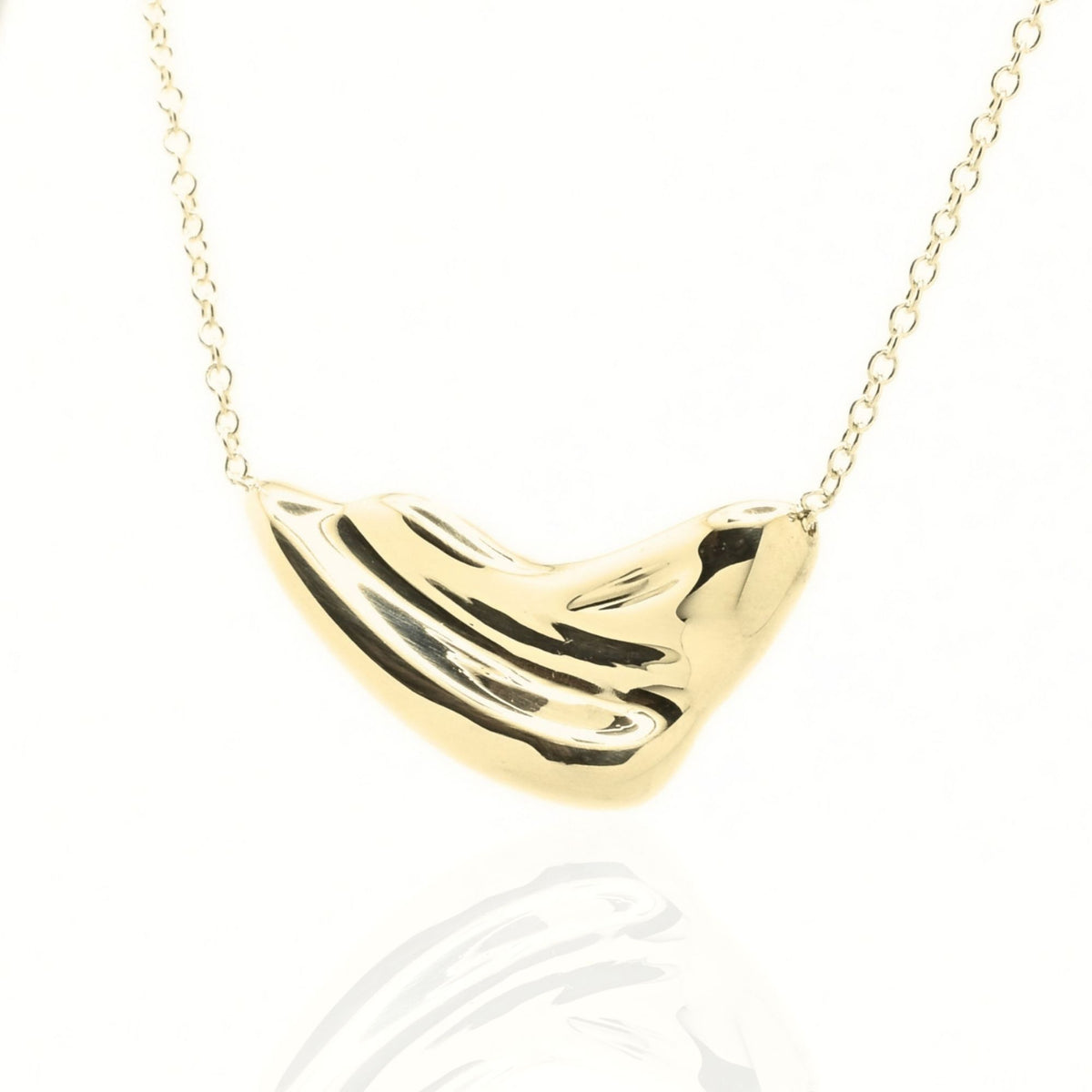 The Pelagic Wave Pendant in 24mm grande scale crafted in solid 18k yellow gold by Gina Rose Atelier, shown with a mirror studio reflection on a custom gold chain.