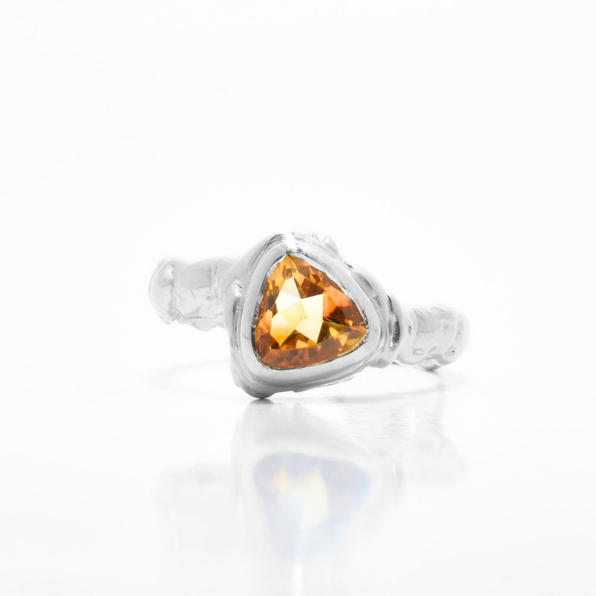 Close-up front view of the Trillion Citrine Solitaire ring from the Archive Series in sterling silver, showcasing master-crafted bezel setting and vibrant golden citrine gemstone by Gina Rose Atelier