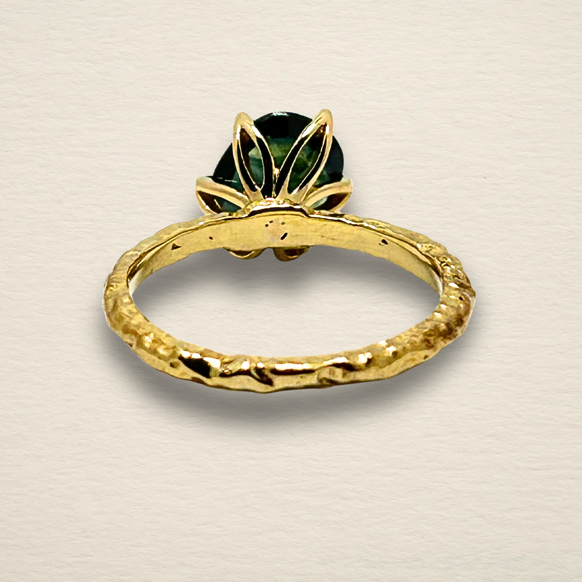 Underside view of the Archive Series Green Sapphire ring, showcasing the precision of the hand-sculpted gold work and the hallmark of authentic master goldsmithing in 18k yellow gold.