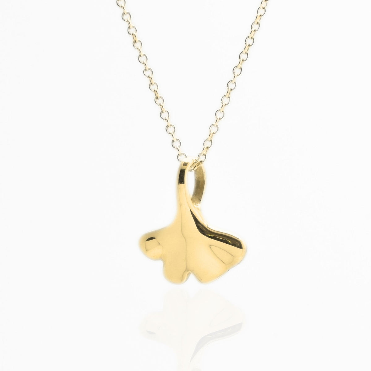 Angled perspective of the Botanical Ginkgo Leaf Pendant 14mm petite in 18k yellow gold, displaying the integrated bail and organic contour by Gina Rose Atelier.