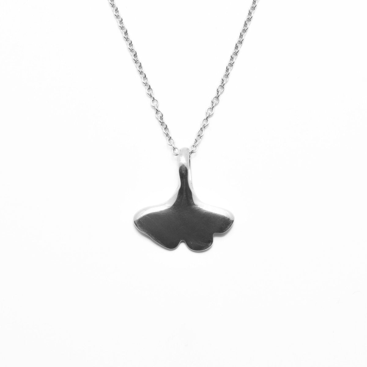 Close-up back view of the Botanical Ginkgo Leaf Pendant 14mm petite in sterling silver, showcasing master-crafted organic fan geometry and polished finish by Gina Rose Atelier