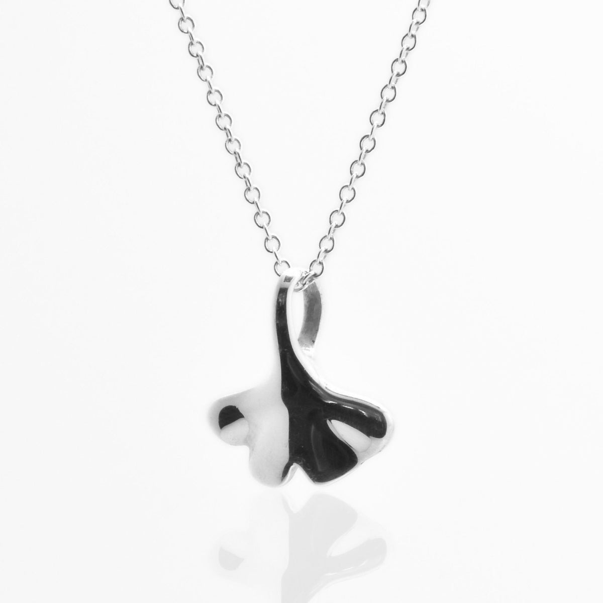 Angled perspective of the Botanical Ginkgo Leaf Pendant 14mm petite in sterling silver, displaying the integrated bail and organic contour by Gina Rose Atelier.