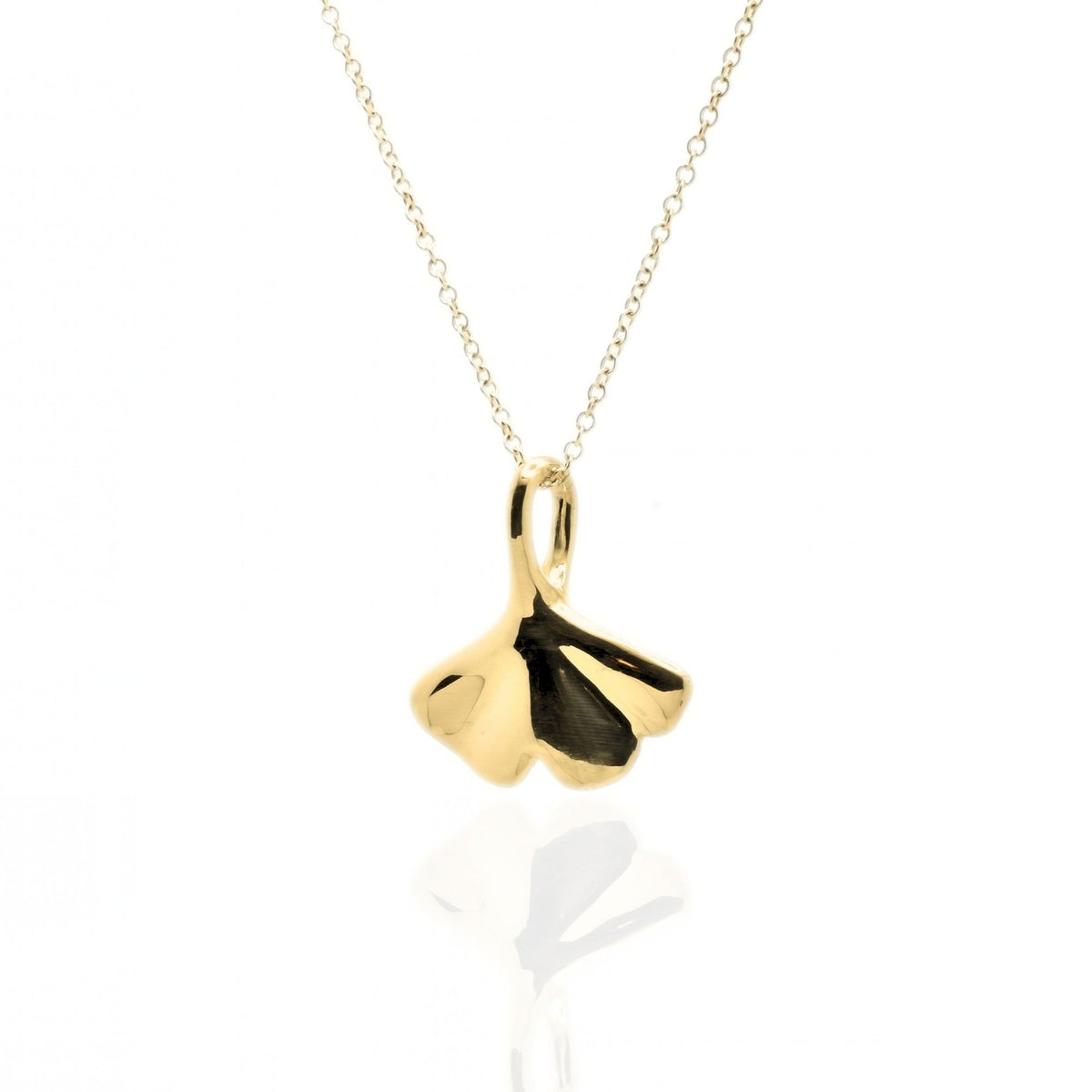 Angled studio shot with reflection of the Botanical Ginkgo Leaf Pendant 20mm in 18k yellow gold, emphasizing the tactile volume and fine jewelry craftsmanship of Gina Rose Atelier.