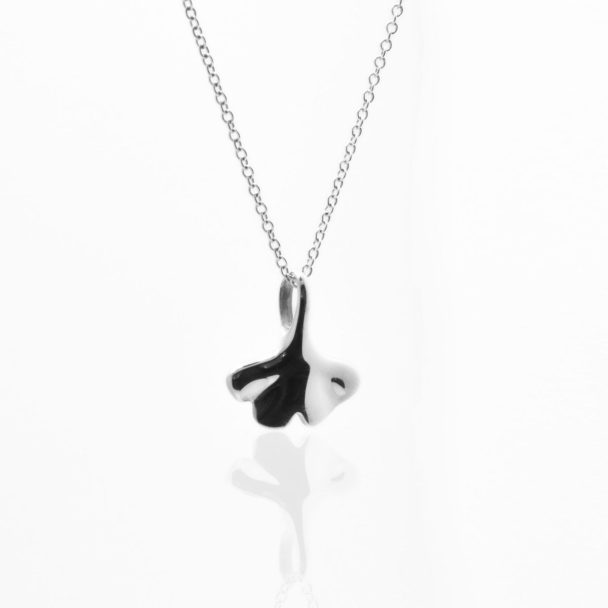 Dynamic studio perspective of the Botanical Ginkgo Leaf Pendant 14mm petite in solid sterling silver, showcasing master metalwork and fluid symmetry by Gina Rose Atelier.