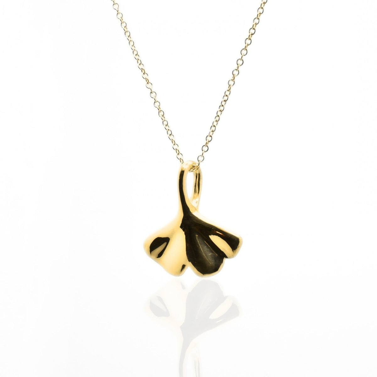 Dynamic studio perspective of the Botanical Ginkgo Leaf Pendant 20mm in 18k yellow gold, showcasing master metalwork and fluid symmetry by Gina Rose Atelier.