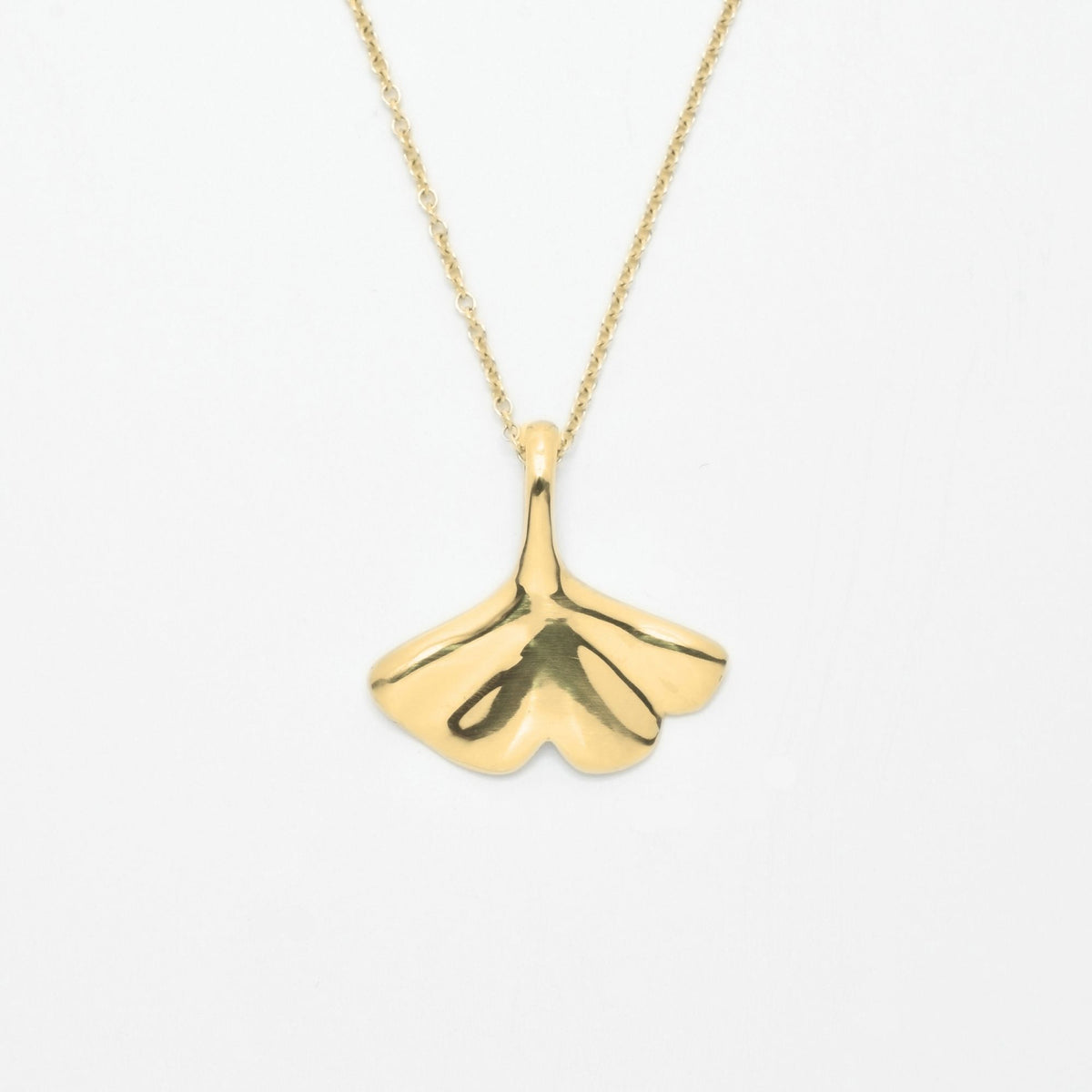 The Botanical Ginkgo Leaf Pendant in 20mm scale crafted in solid 18k yellow gold by Gina Rose Atelier, shown hanging on a custom gold chain against a clean studio background.