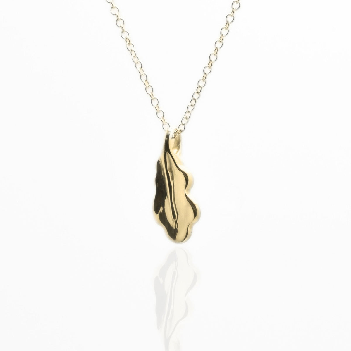 Angled perspective of the Botanical Oak Leaf Pendant 15mm petite in 18k yellow gold, displaying the integrated bail and organic contour by Gina Rose Atelier