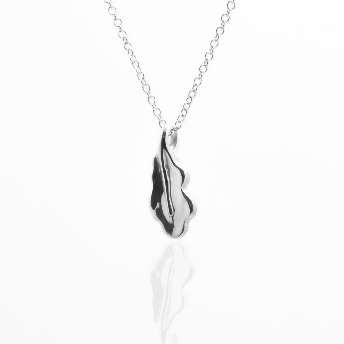 Angled side perspective of the Botanical Oak Leaf Pendant 15mm petite in sterling silver, displaying the integrated bail and organic contour by Gina Rose Atelier.