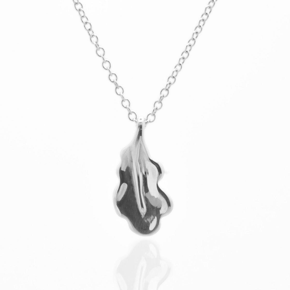 The Botanical Oak Leaf Pendant in 15mm petite scale crafted in solid sterling silver by Gina Rose Atelier, shown with a mirror studio reflection on a custom silver chain.