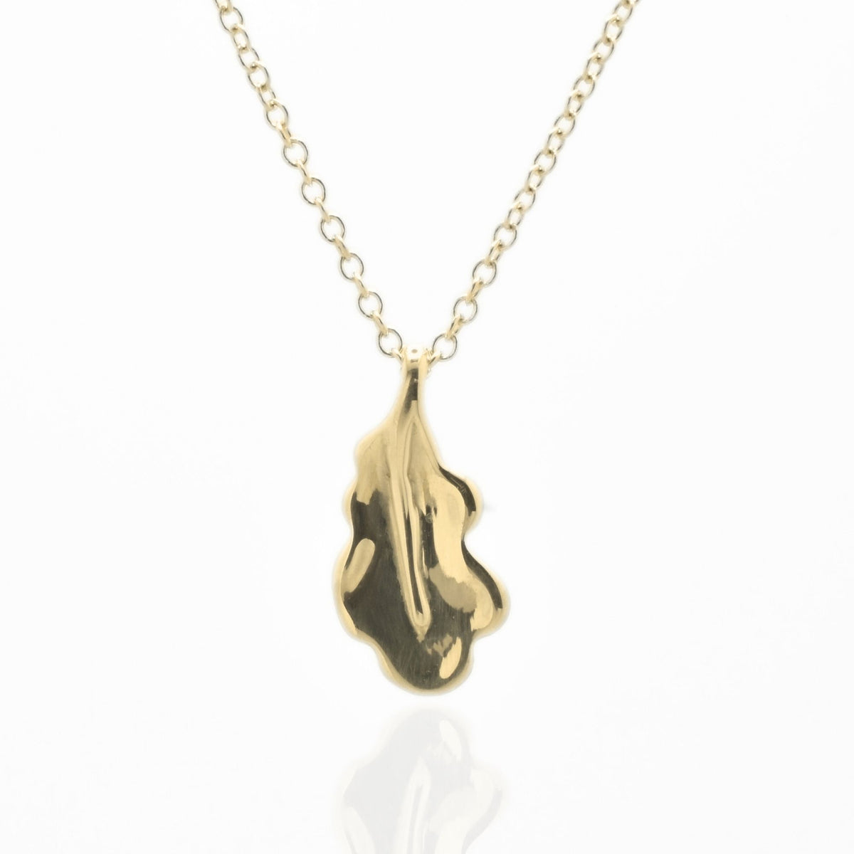 The Botanical Oak Leaf Pendant in 15mm petite scale crafted in solid 18k yellow gold by Gina Rose Atelier, shown with a mirror studio reflection on a custom gold chain