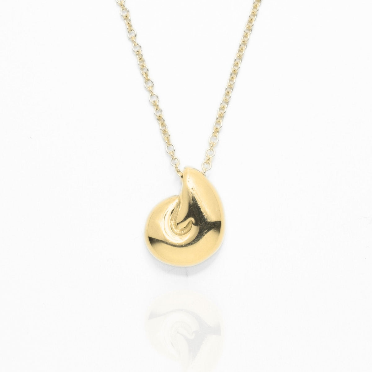 Close-up front view of the Pelagic Nautilus Pendant 11mm petite in 18k yellow gold, showcasing master-crafted logarithmic spiral geometry and polished finish by Gina Rose Atelier.