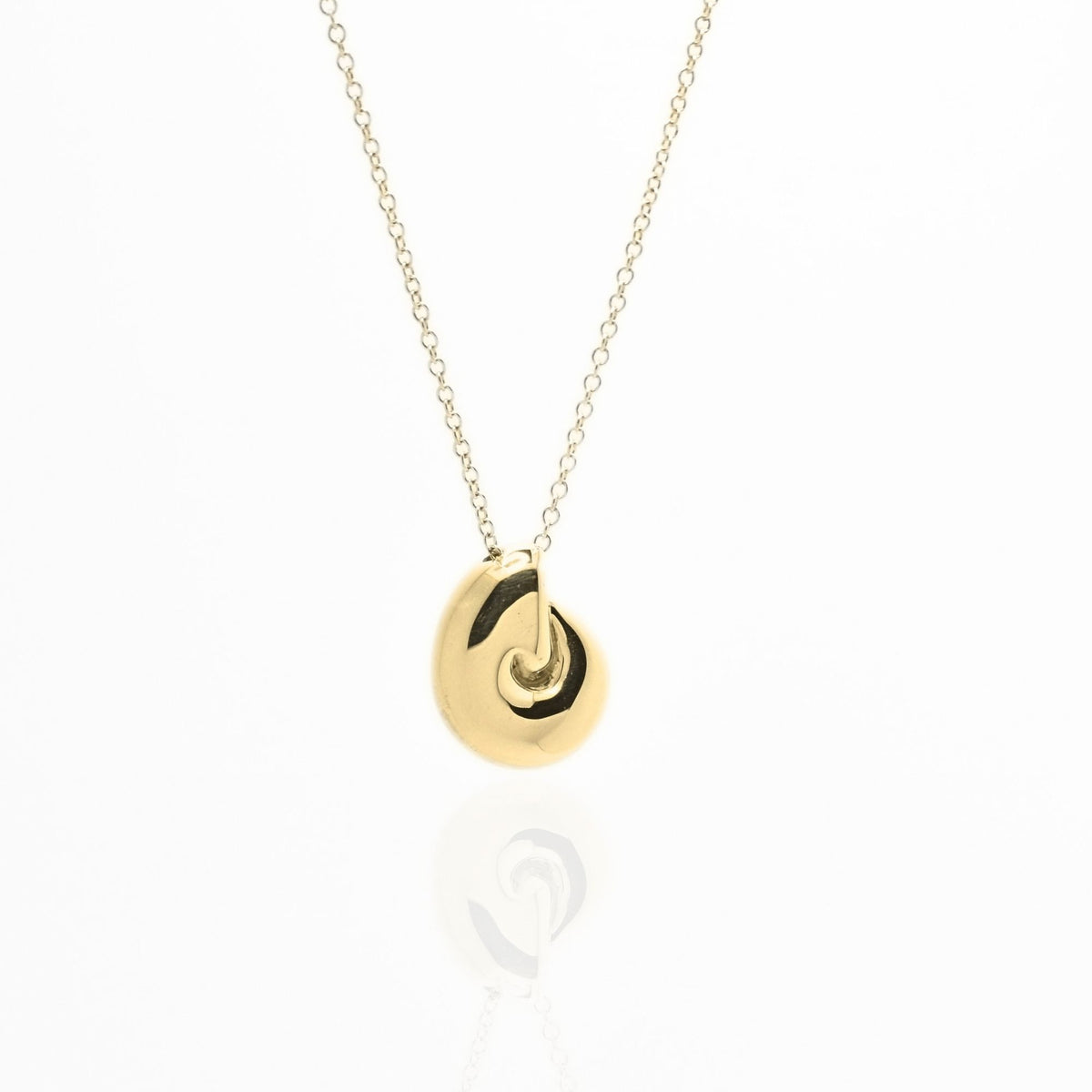 Angled perspective of the Pelagic Nautilus Pendant 14mm grande in 18k yellow gold, displaying the integrated bail and organic shell contour by Gina Rose Atelier.