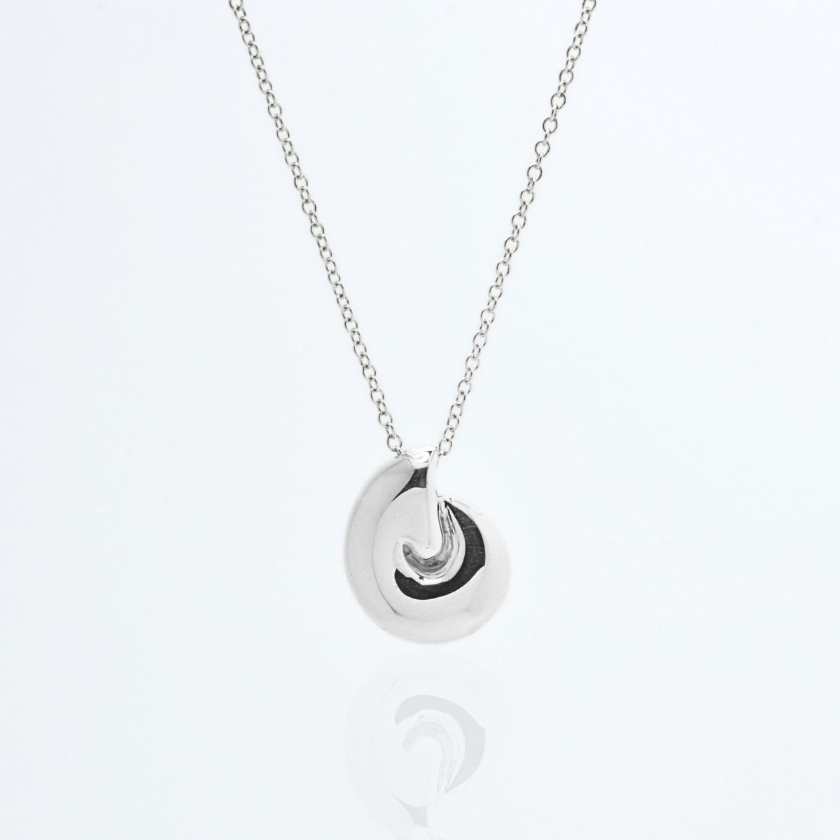 Close-up front view of the Pelagic Nautilus Pendant 14mm grande in sterling silver, showcasing master-crafted logarithmic spiral geometry and polished finish by Gina Rose Atelier