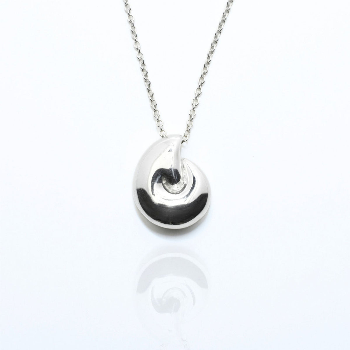 Angled perspective of the Pelagic Nautilus Pendant 14mm grande in sterling silver, displaying the integrated bail and organic shell contour by Gina Rose Atelier