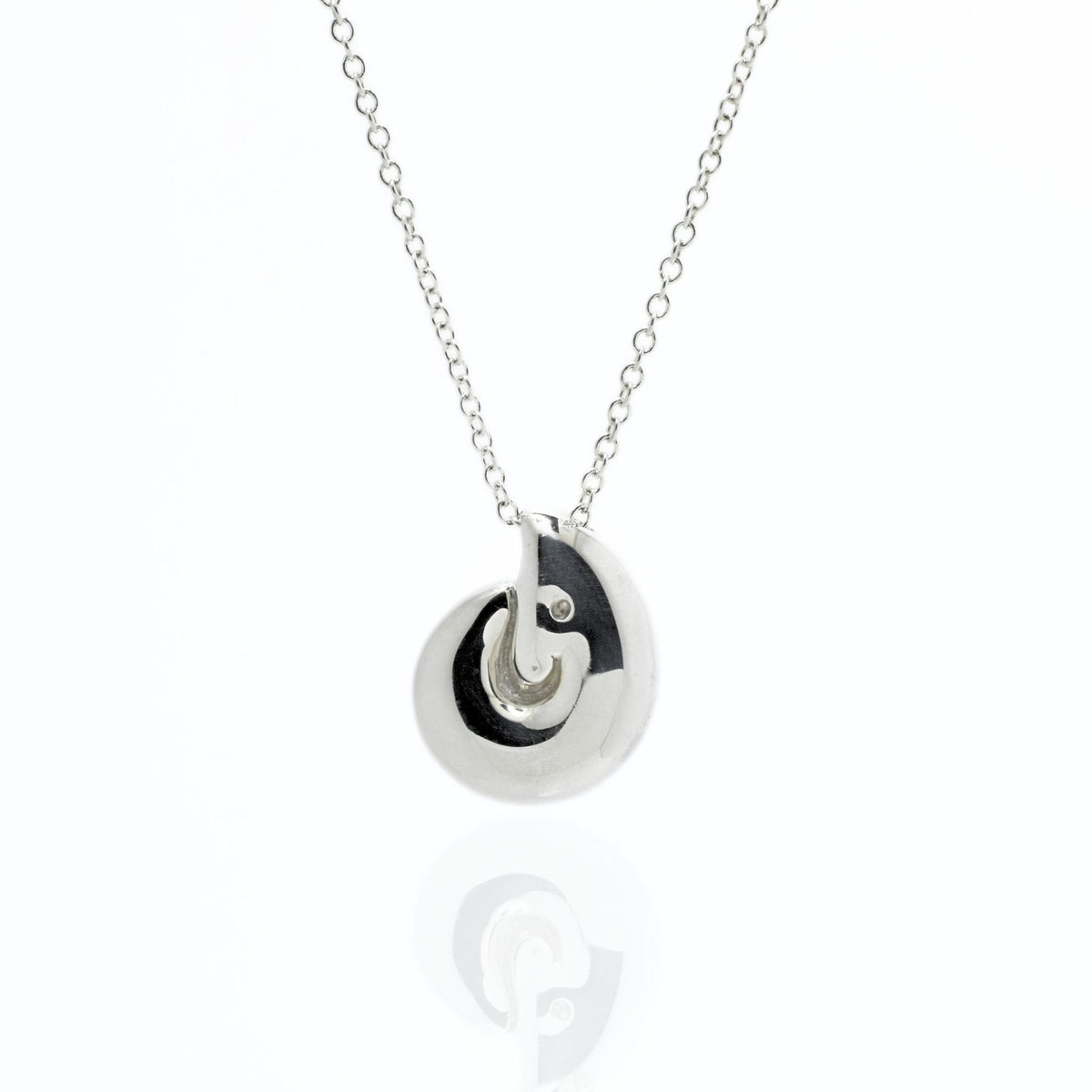 Studio reflection view of the Pelagic Nautilus Pendant 14mm grande in sterling silver, highlighting hand-finished architectural contours and sovereign luste
