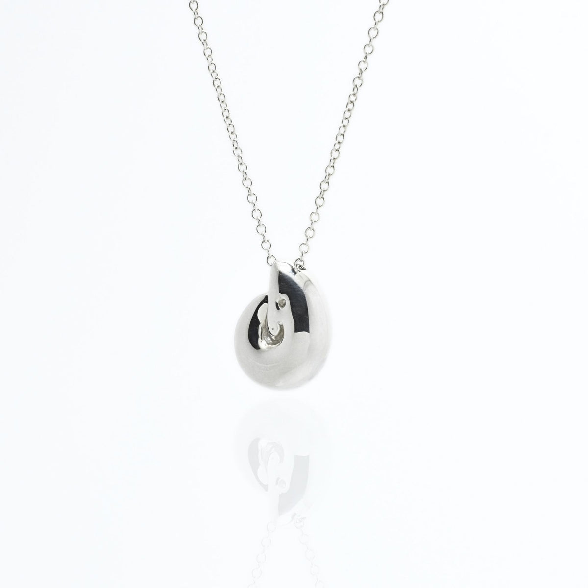 Dynamic studio perspective and mirror reflection of the Pelagic Nautilus Pendant 14mm grande in solid sterling silver by Gina Rose Atelier.