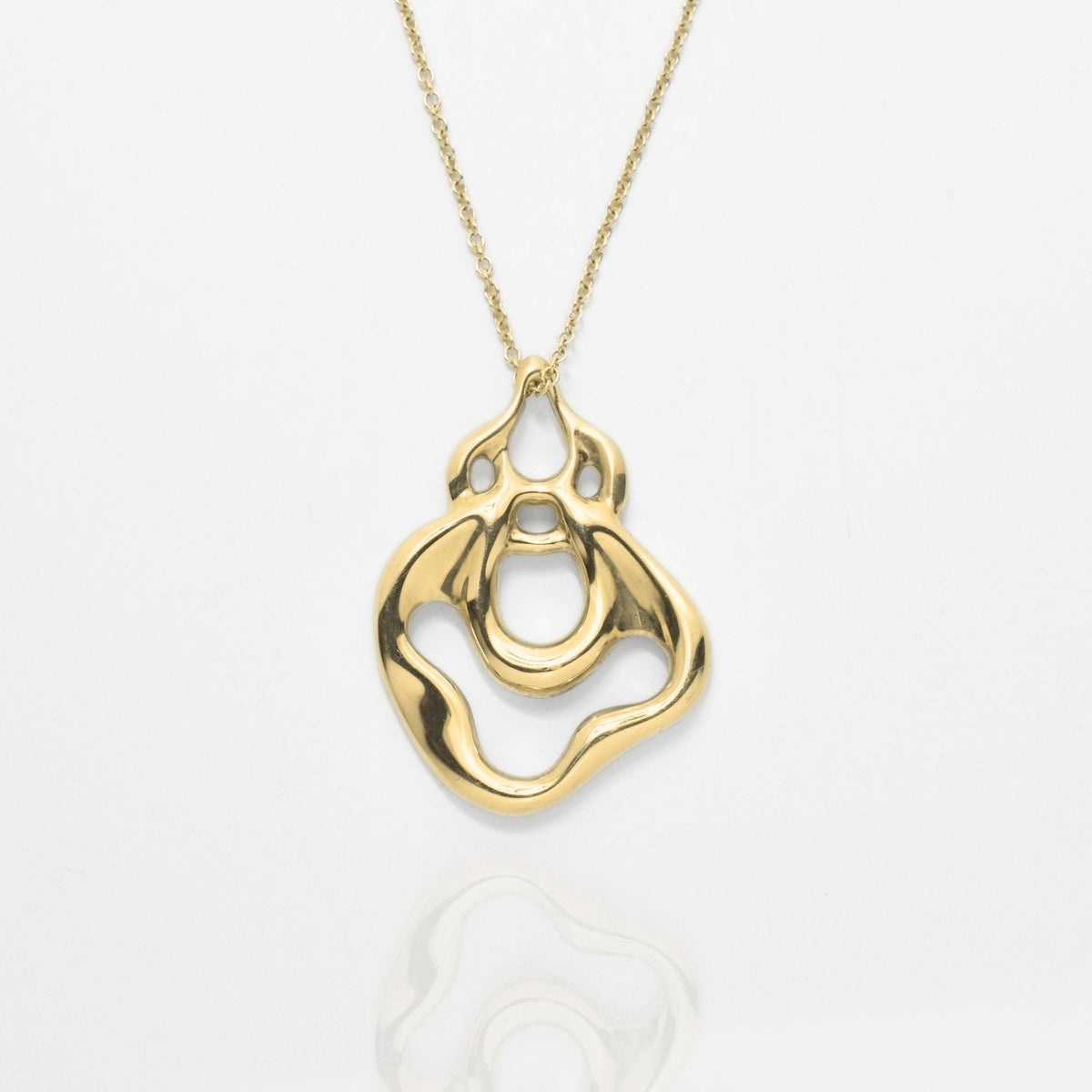 Studio reflection view of the Pelagic Sea Fan Pendant 29mm grande in solid 18k yellow gold, highlighting intricate branching coral architecture and sovereign luster from Gina Rose Atelier