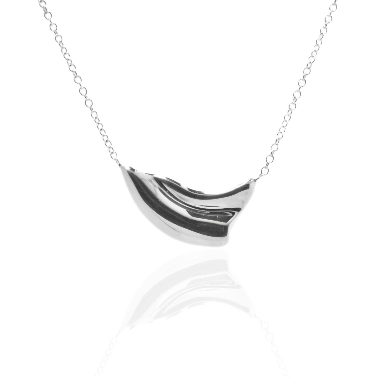 Close-up front view of the Pelagic Wave Pendant 18mm petite in sterling silver, showcasing master-crafted sweeping crest geometry and polished finish by Gina Rose Atelier.