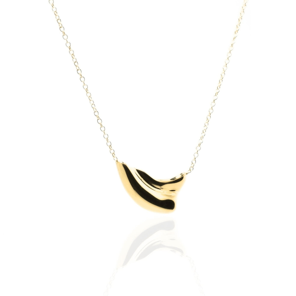 Dynamic studio perspective and mirror reflection of the Pelagic Wave Pendant 18mm petite in solid 18k yellow gold by Gina Rose Atelier.