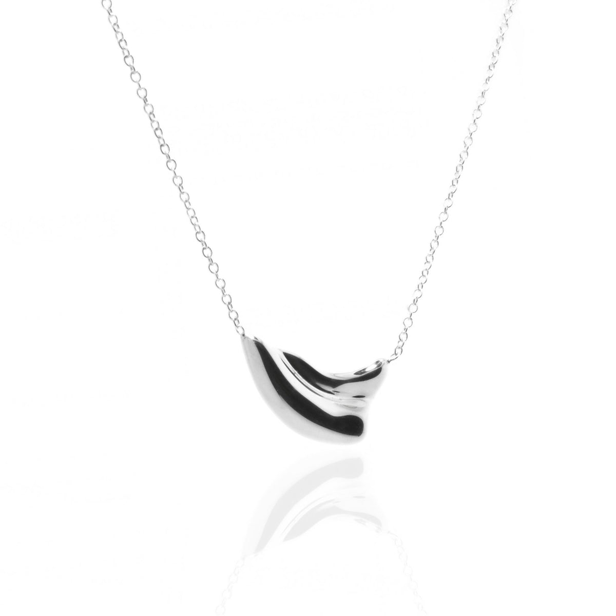 Dynamic studio perspective and mirror reflection of the Pelagic Wave Pendant 18mm petite in solid sterling silver by Gina Rose Atelier.