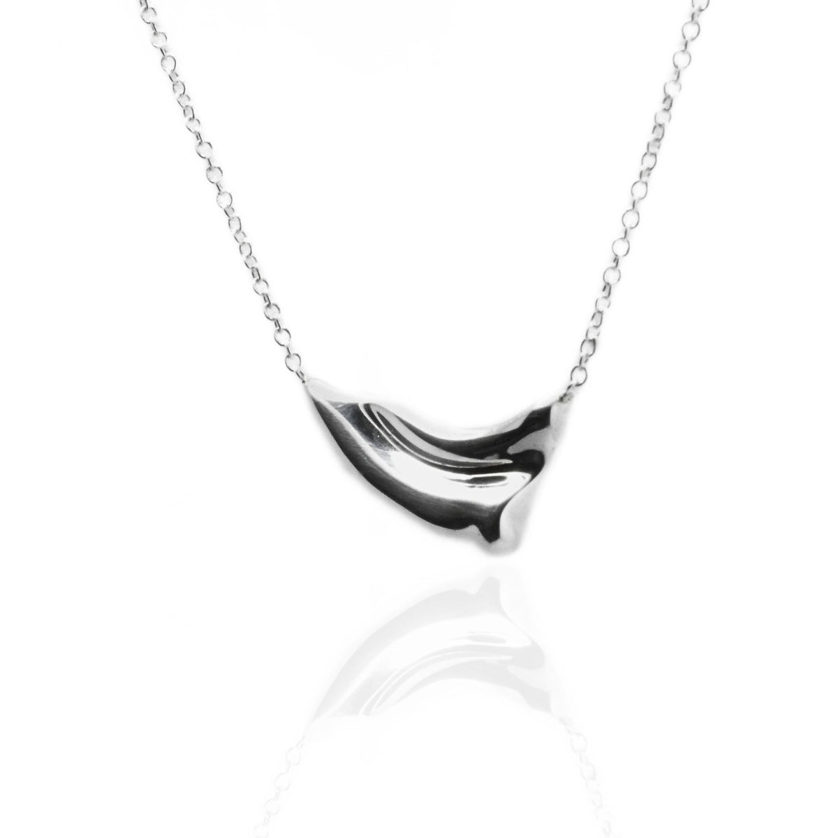 The Pelagic Wave Pendant in 18mm petite scale crafted in solid sterling silver by Gina Rose Atelier, shown with a mirror studio reflection on a custom silver chain.