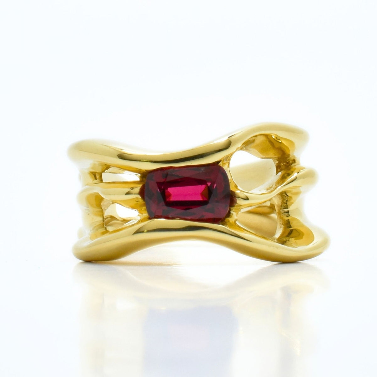 Detailed view of the custom-cut red spinel center stone set within the organic 18k yellow gold band of the Archive Series master ring by Gina Rose Atelier