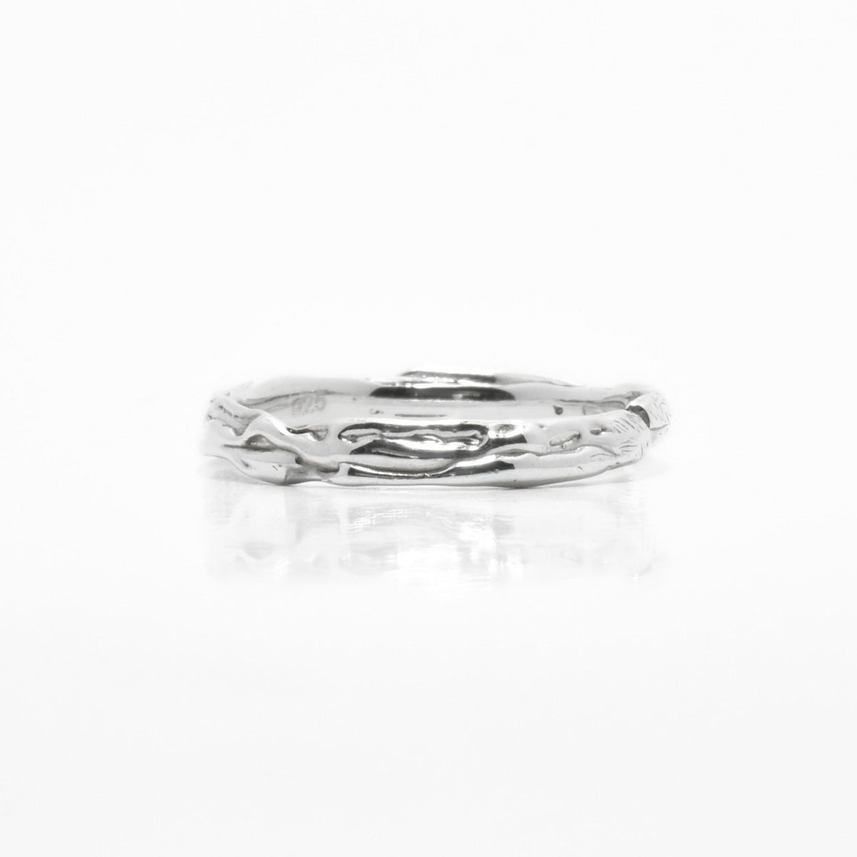 Close-up texture detail of the Sculpted Silver Band in sterling silver, showcasing hand-carved organic surface architecture by Gina Rose Atelier.
