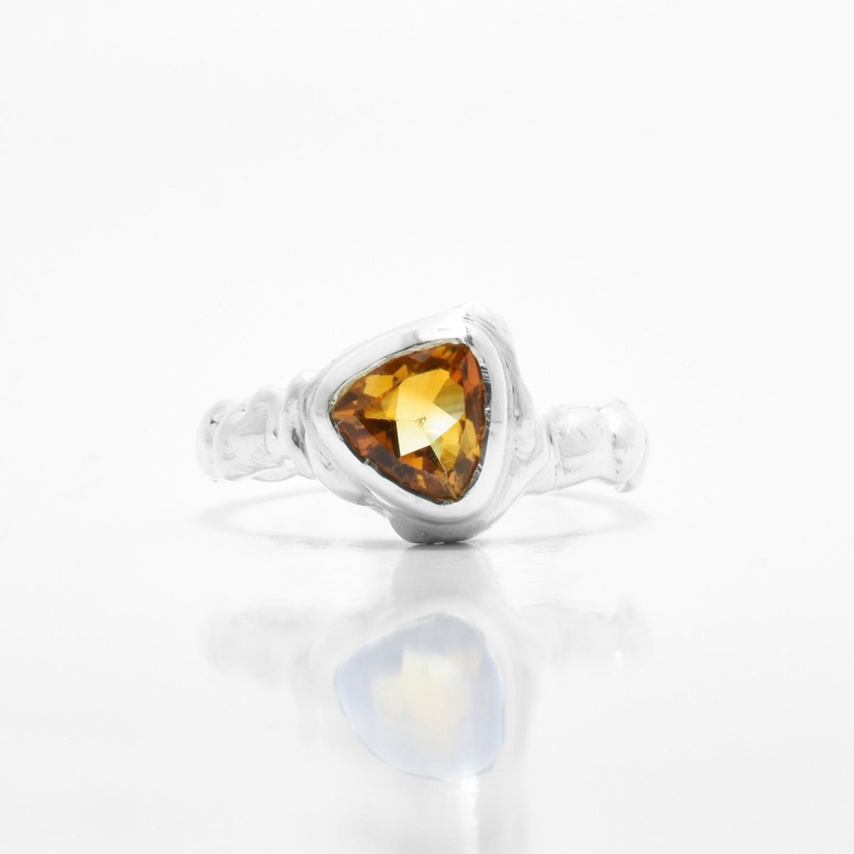 The Trillion Citrine Solitaire ring from the Archive Series crafted in solid sterling silver featuring a precision trillion-cut citrine gemstone by Gina Rose Atelier, shown with a mirror studio reflection